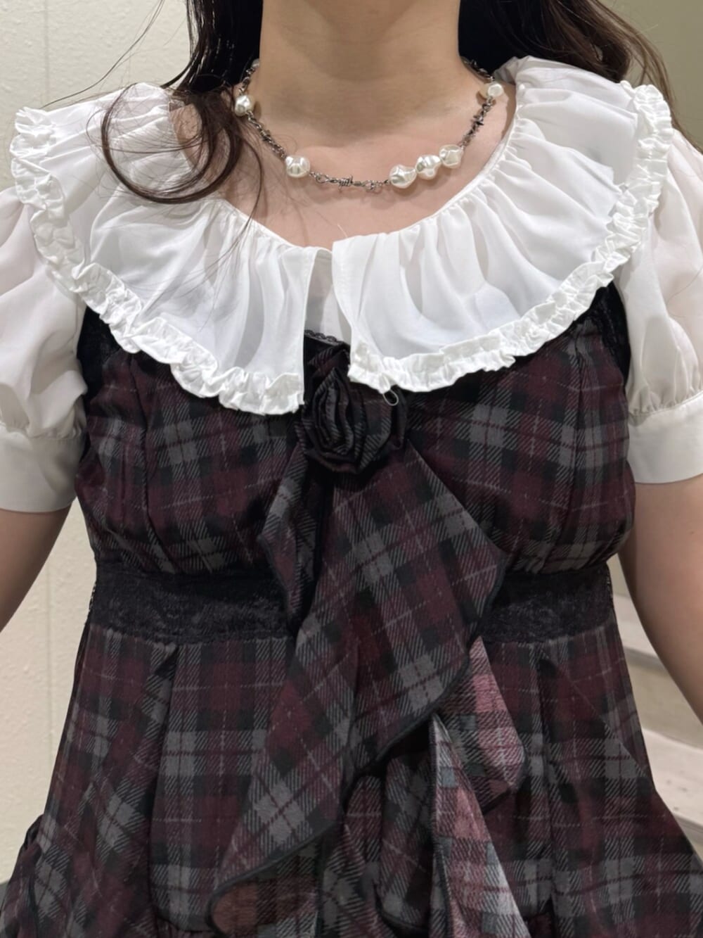 ホワイト系のシャツ/ブラウス、ブラック系のハンドバッグ、ブラック系のブーツを着用したレディースの夏コーディネートの7枚目の写真