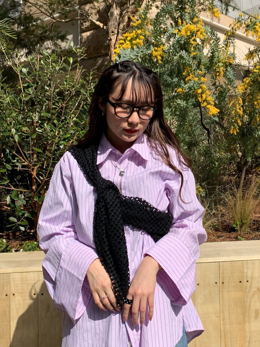 ピンク系のシャツ/ブラウス、ブラック系のTシャツ/カットソー、ブルー系のデニムパンツを着用したレディースの春コーディネートの4枚目の写真