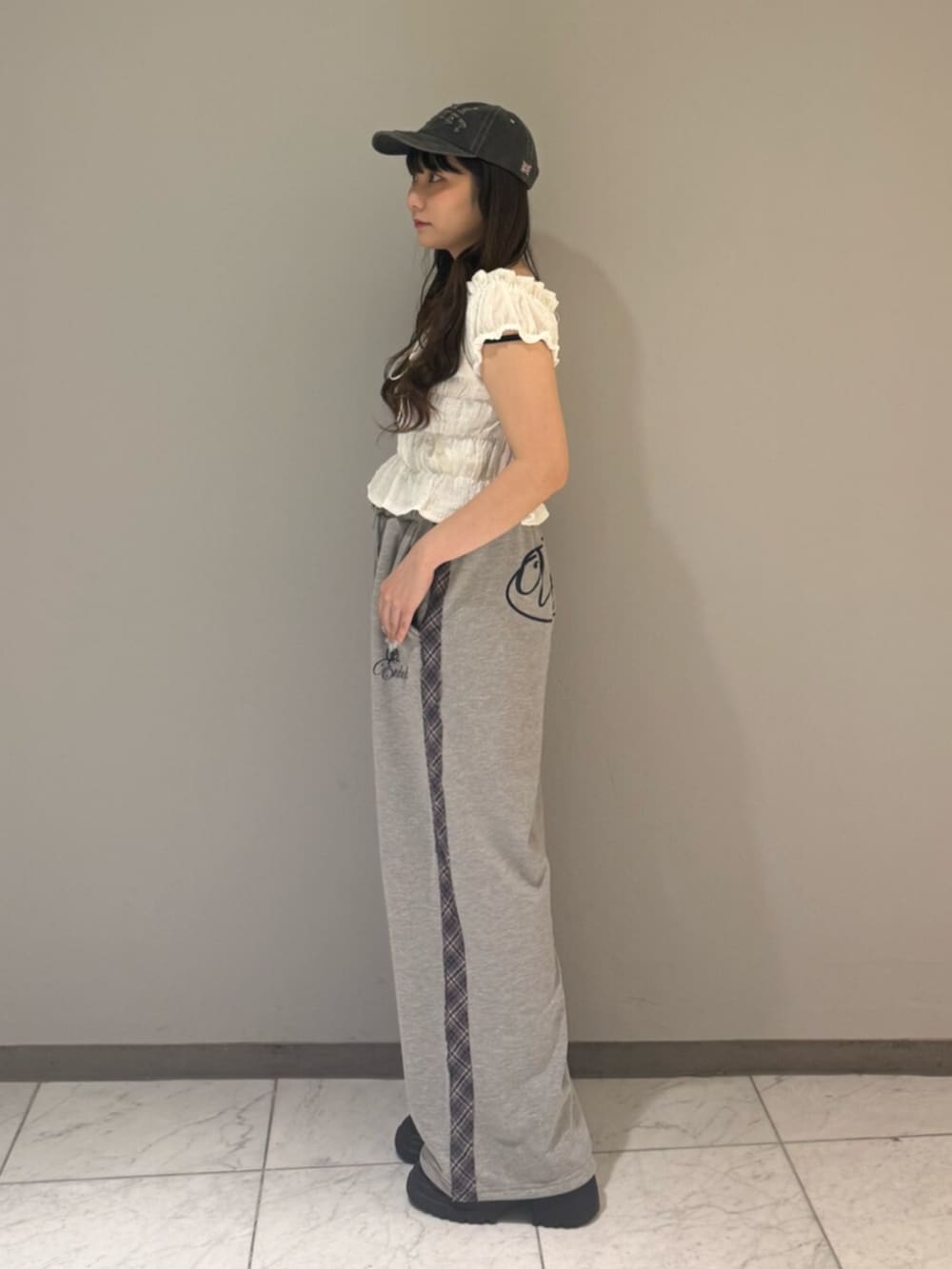 ブラック系のブーツ、ホワイト系のシャツ/ブラウス、グレー系のその他パンツを着用したレディースの夏コーディネートの3枚目の写真