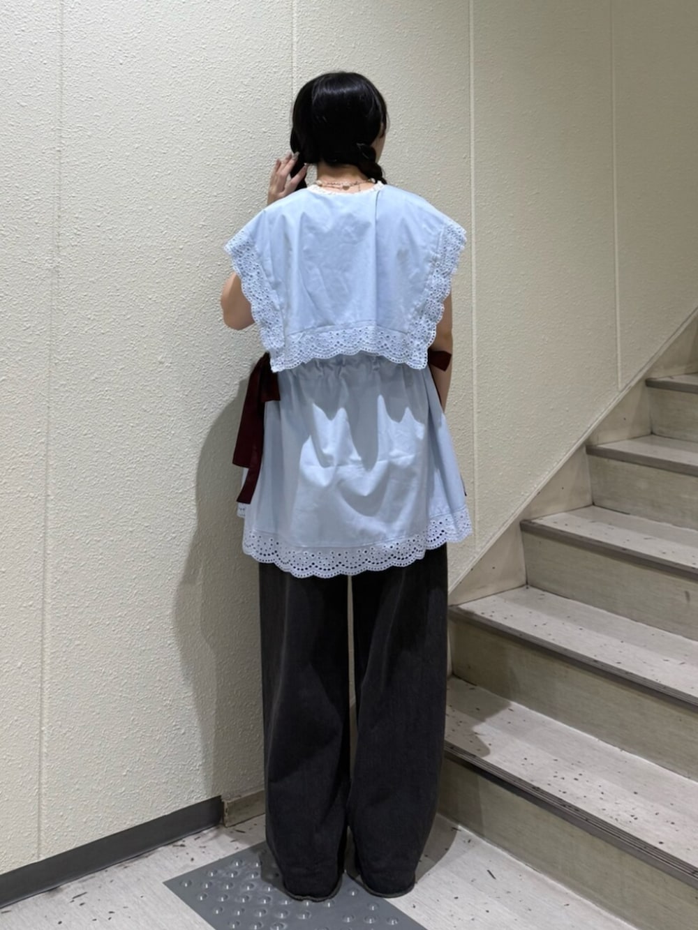 ブラック系のブーツ、ブラック系のデニムパンツ、ホワイト系のタンクトップを着用したレディースの夏コーディネートの3枚目の写真
