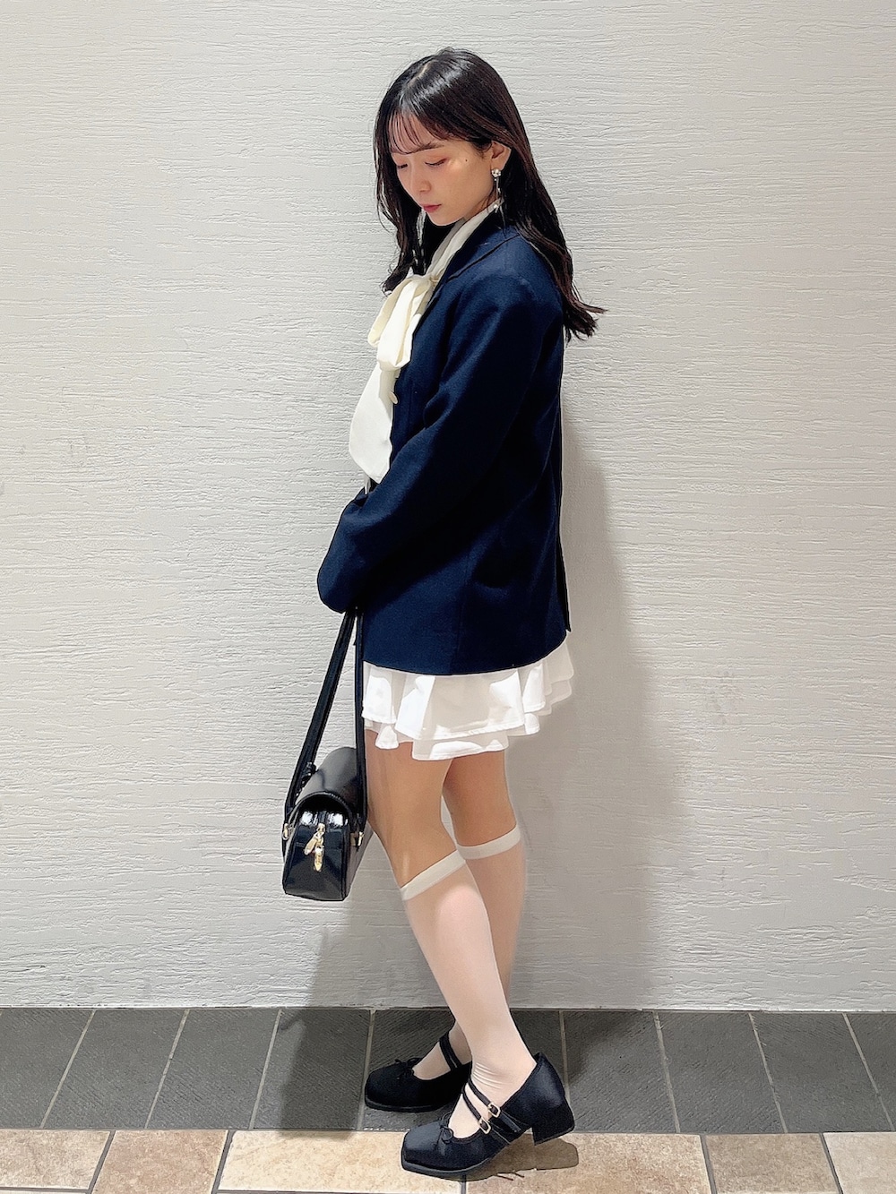 ホワイト系のシャツ/ブラウス、ホワイト系のスカート、ブラック系のバレエシューズを着用したレディースの春コーディネートの5枚目の写真