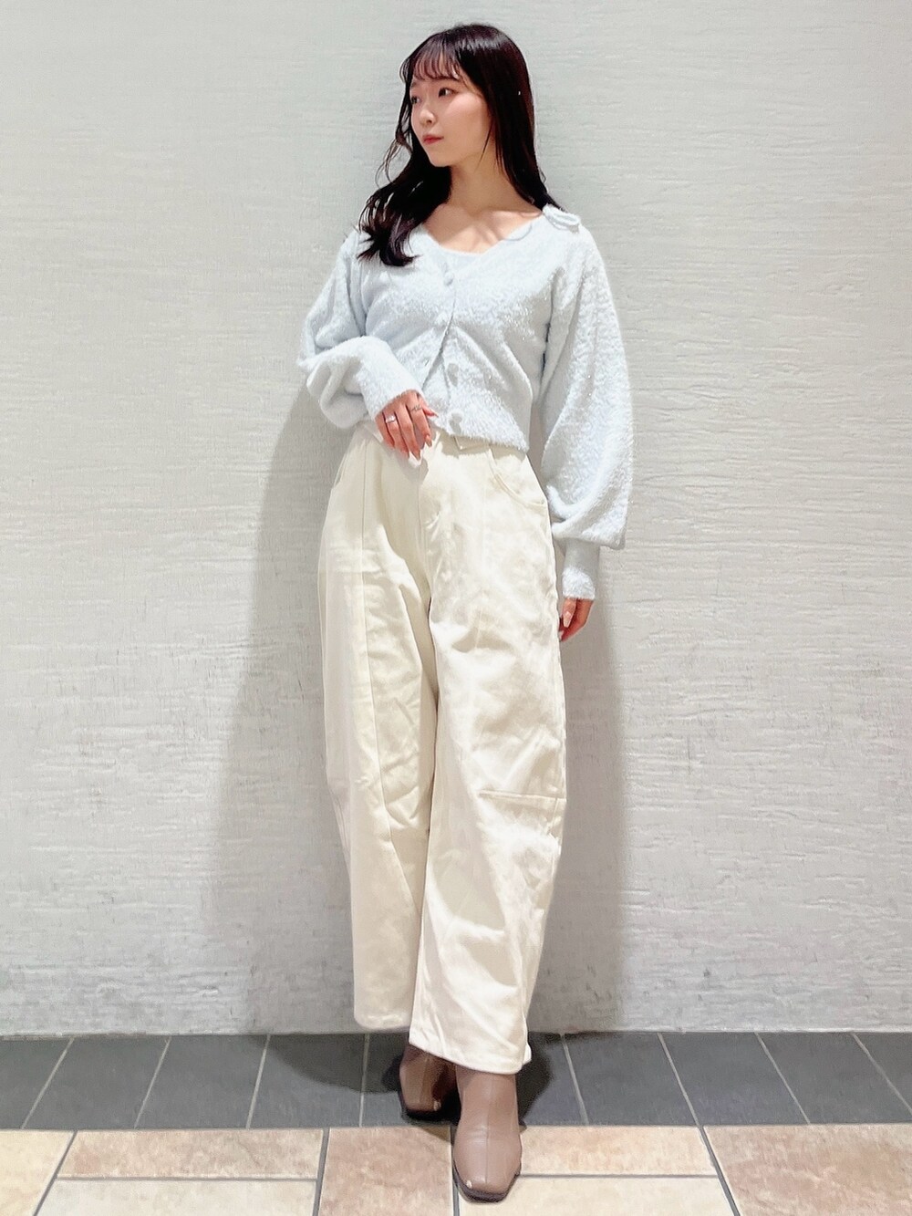 グレー系のキャミソール、グレー系のカーディガン/ボレロ、ホワイト系のデニムパンツを着用したレディースの冬コーディネートの2枚目の写真