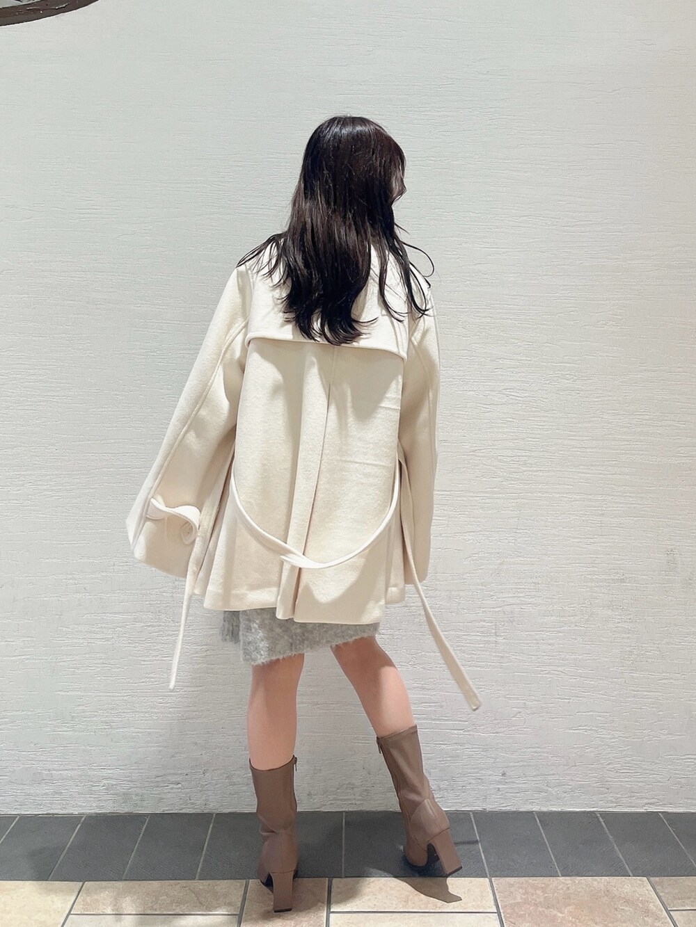 ベージュ系のブーツ、ホワイト系のダッフルコート、ピンク系のニット/セーターを着用したレディースの秋コーディネートの4枚目の写真