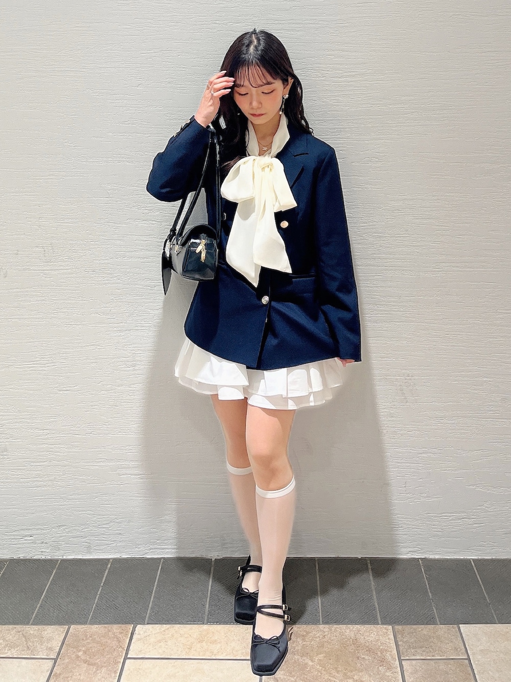 ホワイト系のシャツ/ブラウス、ホワイト系のスカート、ブラック系のバレエシューズを着用したレディースの春コーディネートの2枚目の写真