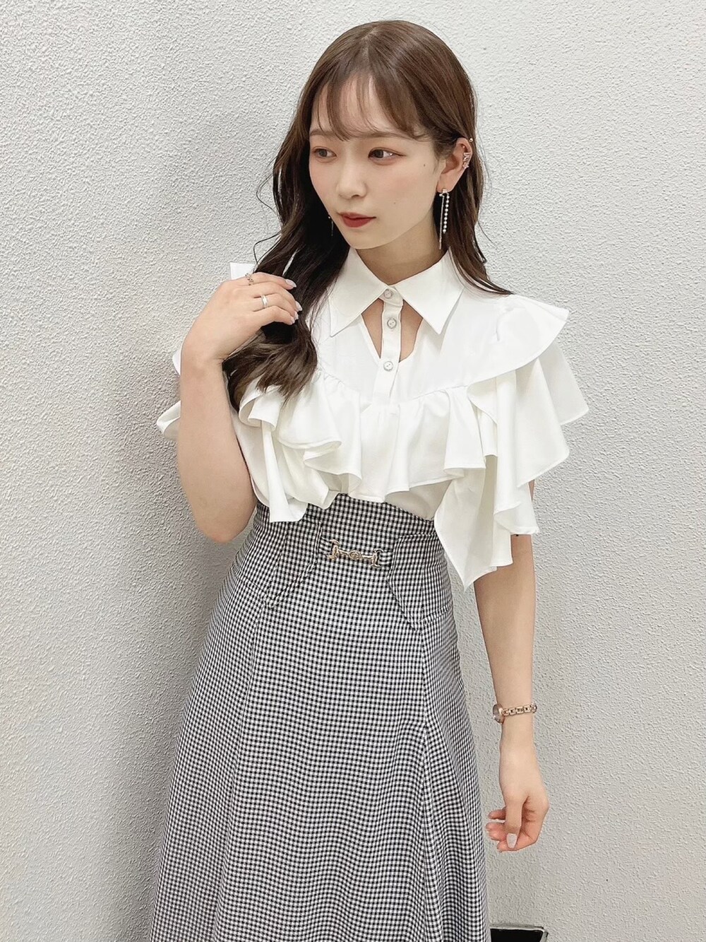 ホワイト系のシャツ/ブラウス、ブラック系のスカート、ホワイト系のパンプスを着用したレディースの夏コーディネートの10枚目の写真