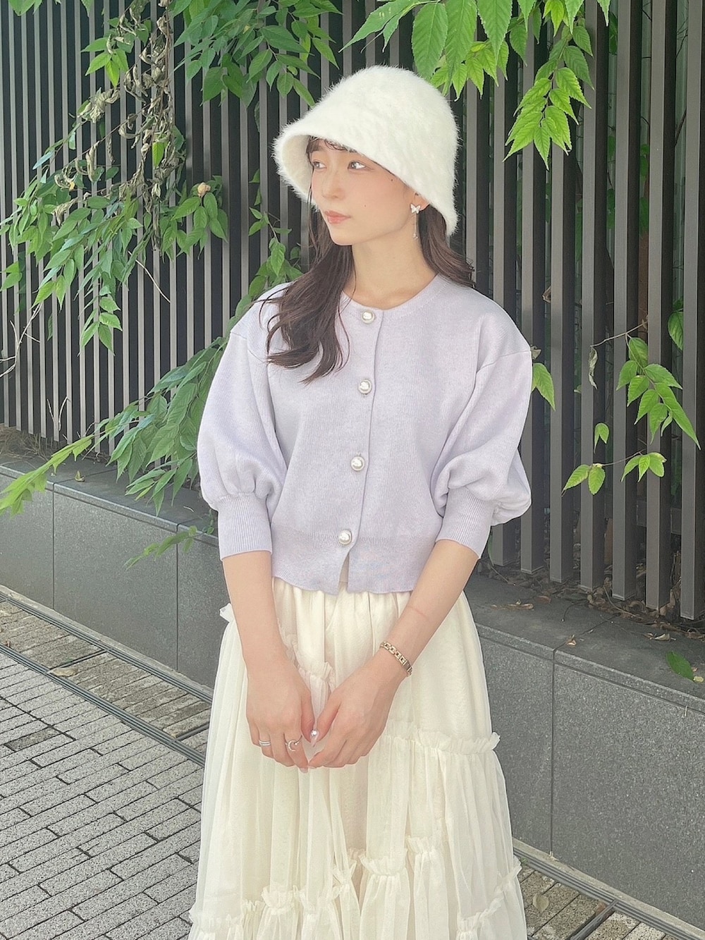 パープル系のカーディガン/ボレロ、ホワイト系のスカート、ホワイト系のブーツを着用したレディースの夏コーディネートの10枚目の写真