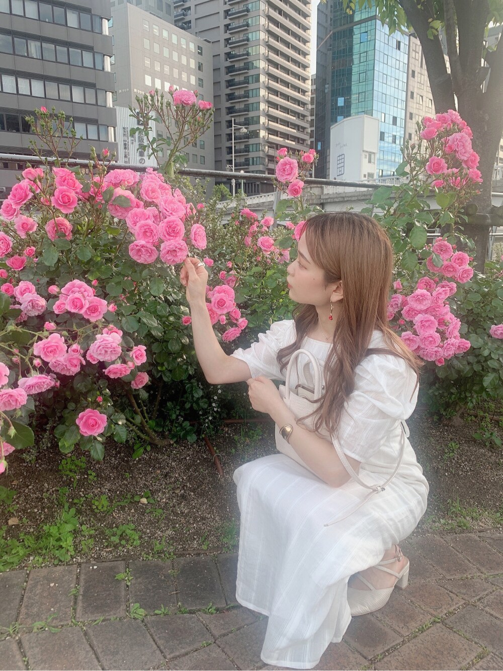 ホワイト系のパンプス、ホワイト系のワンピースを着用したレディースの春コーディネートの5枚目の写真