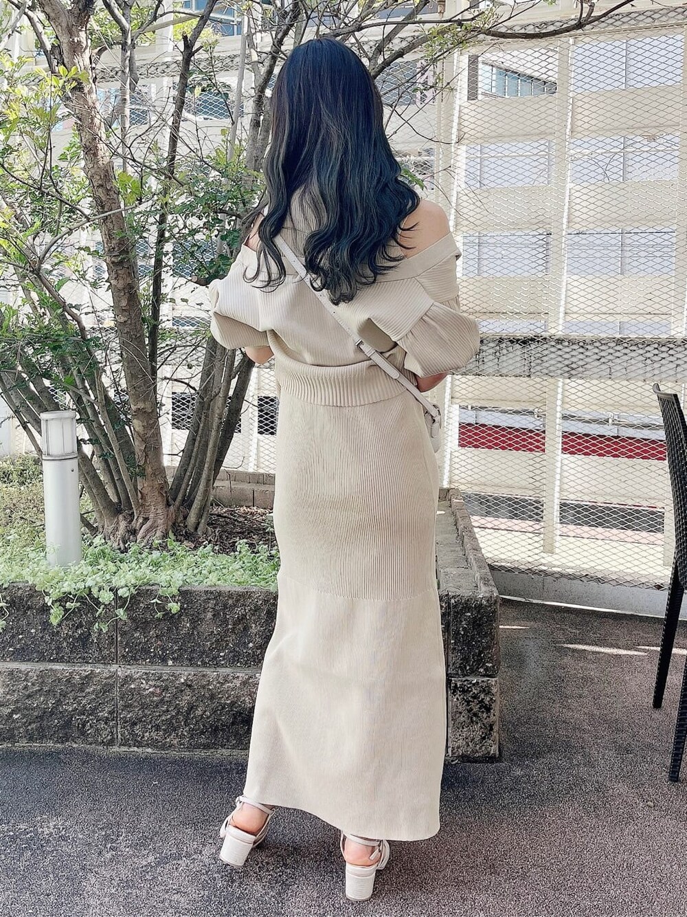 ホワイト系のパンプス、ホワイト系のショルダーバッグ、ベージュ系のワンピースを着用したレディースの春コーディネートの3枚目の写真