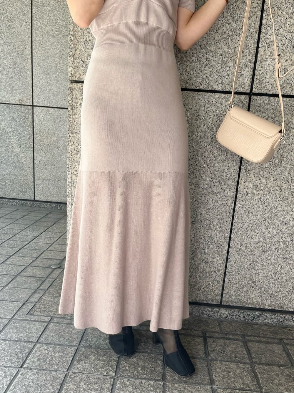 ピンク系のワンピース、ブラック系のブーツ、ホワイト系のショルダーバッグを着用したレディースの冬コーディネートの10枚目の写真