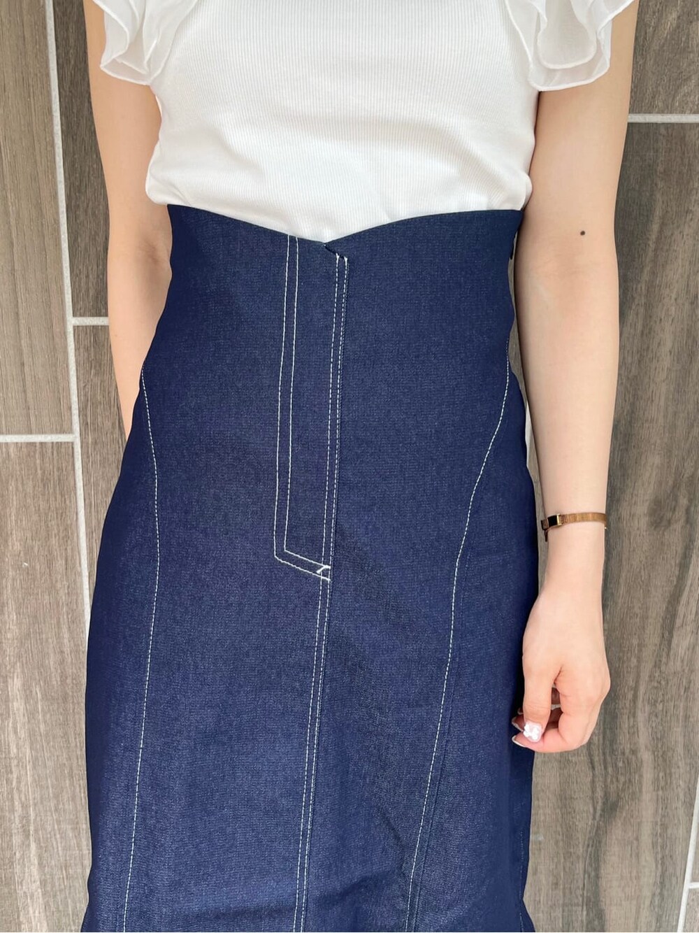 ブルー系のスカート、ホワイト系のTシャツ/カットソー、ホワイト系のパンプスを着用したレディースの夏コーディネートの7枚目の写真