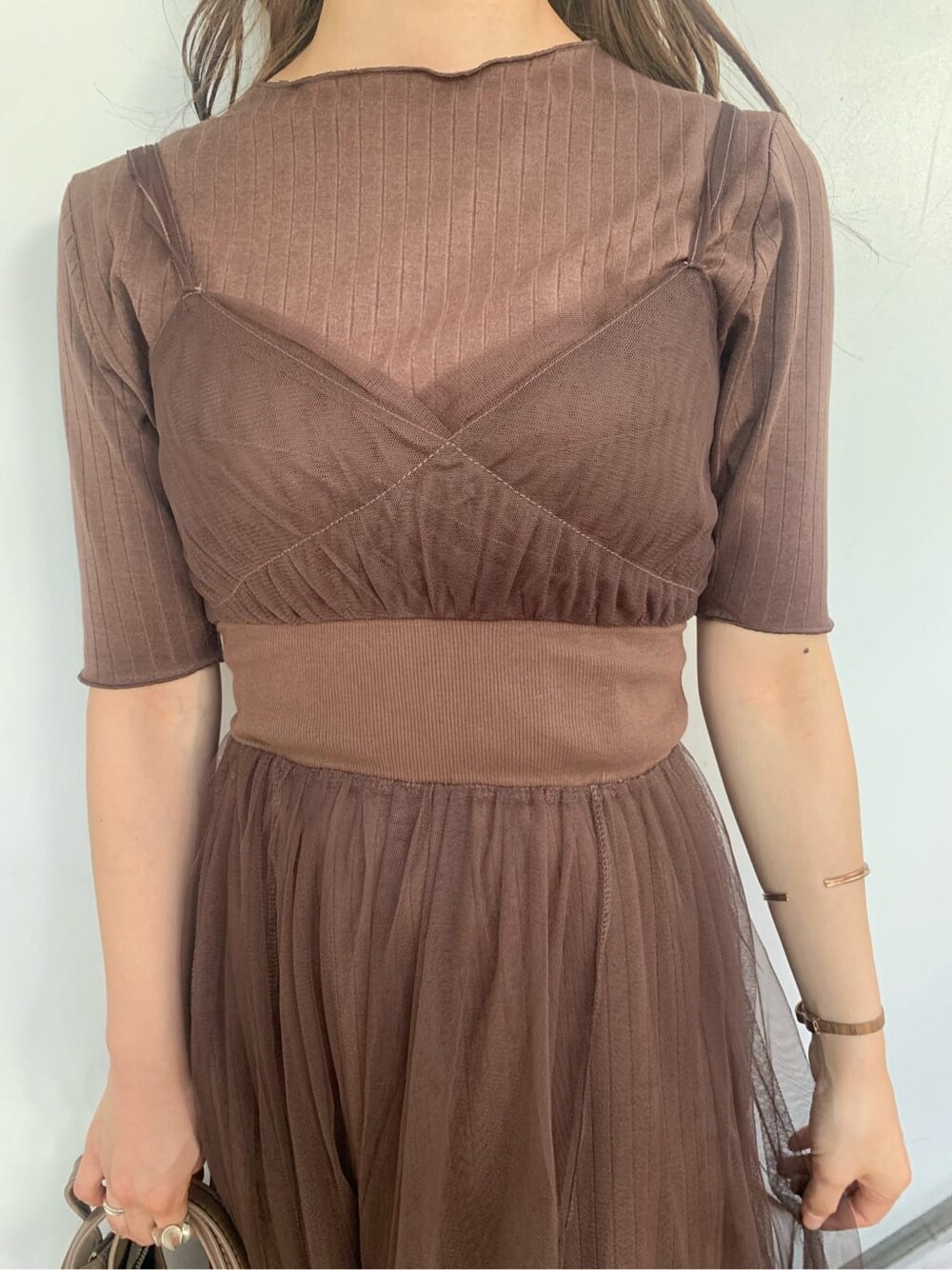 ブラウン系のワンピース、ブラウン系のパンプス、ベージュ系のハンドバッグを着用したレディースの秋コーディネートの4枚目の写真