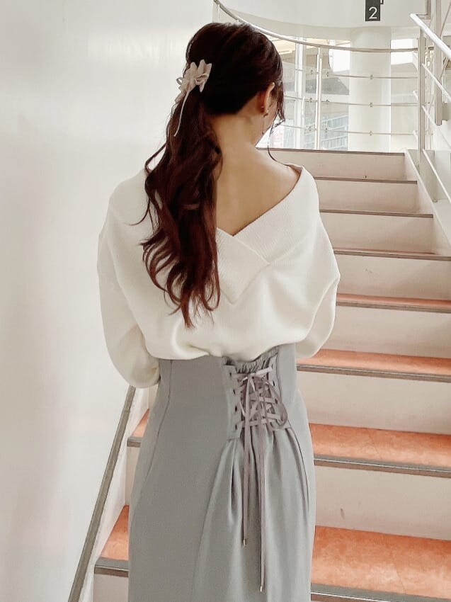 ベージュ系のブーツ、グレー系のスカート、ホワイト系のニット/セーターを着用したレディースの秋コーディネートの7枚目の写真