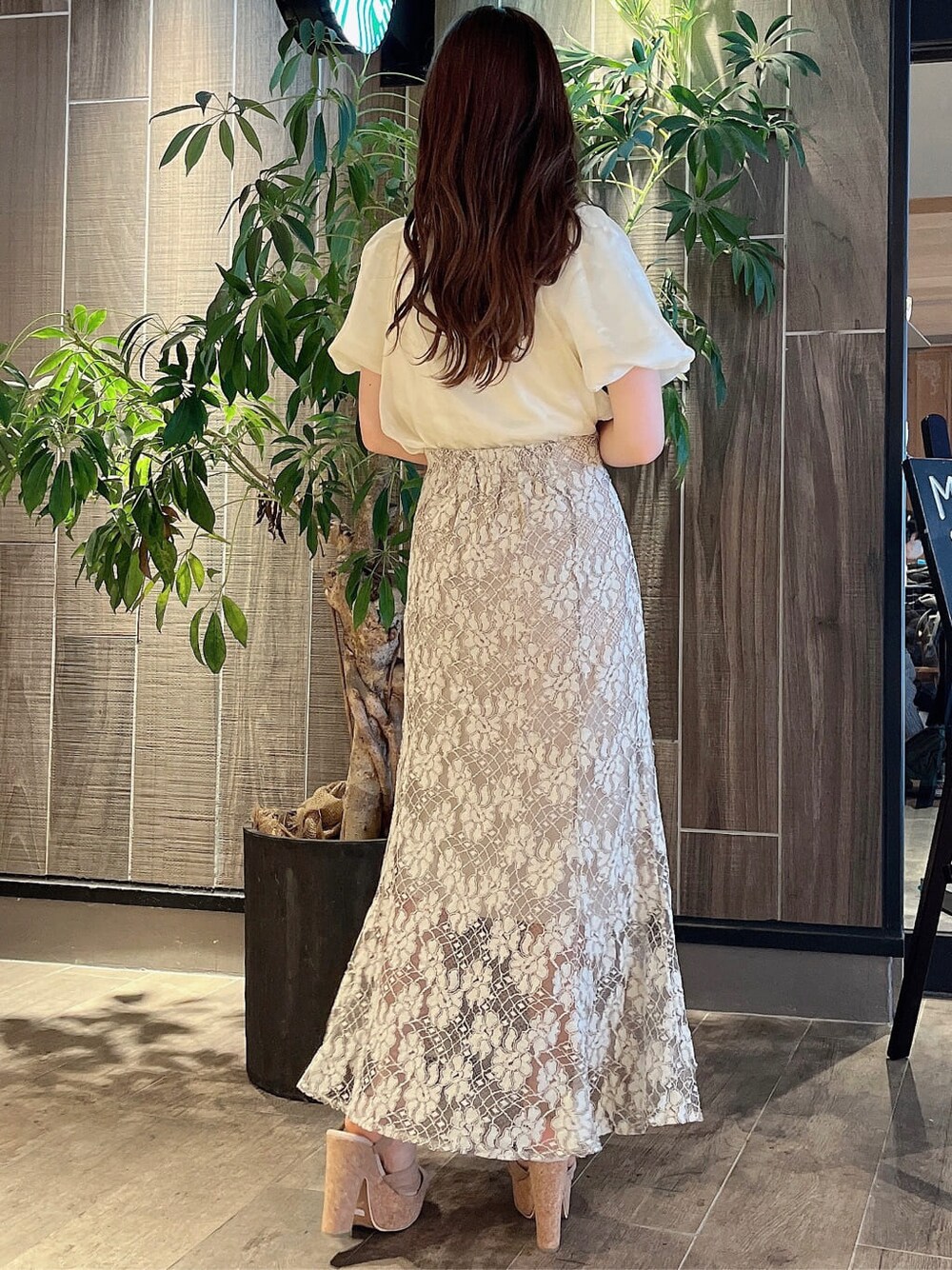 ベージュ系のスカート、ベージュ系のサンダル、イエロー系のシャツ/ブラウスを着用したレディースの夏コーディネートの4枚目の写真