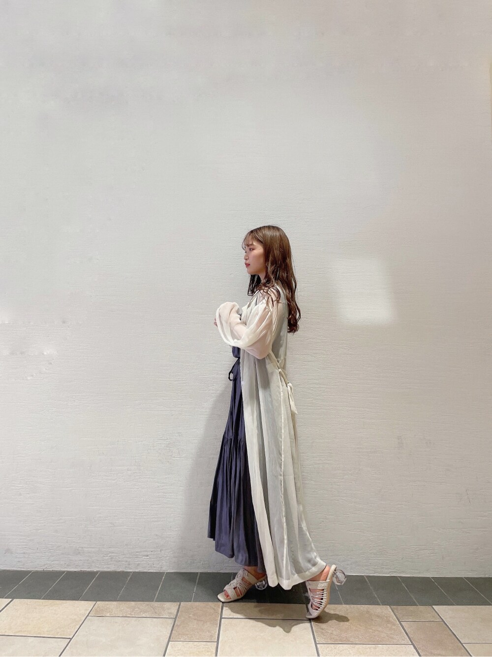 パープル系のワンピース、ホワイト系のサンダル、ホワイト系のシャツ/ブラウスを着用したレディースの春コーディネートの4枚目の写真