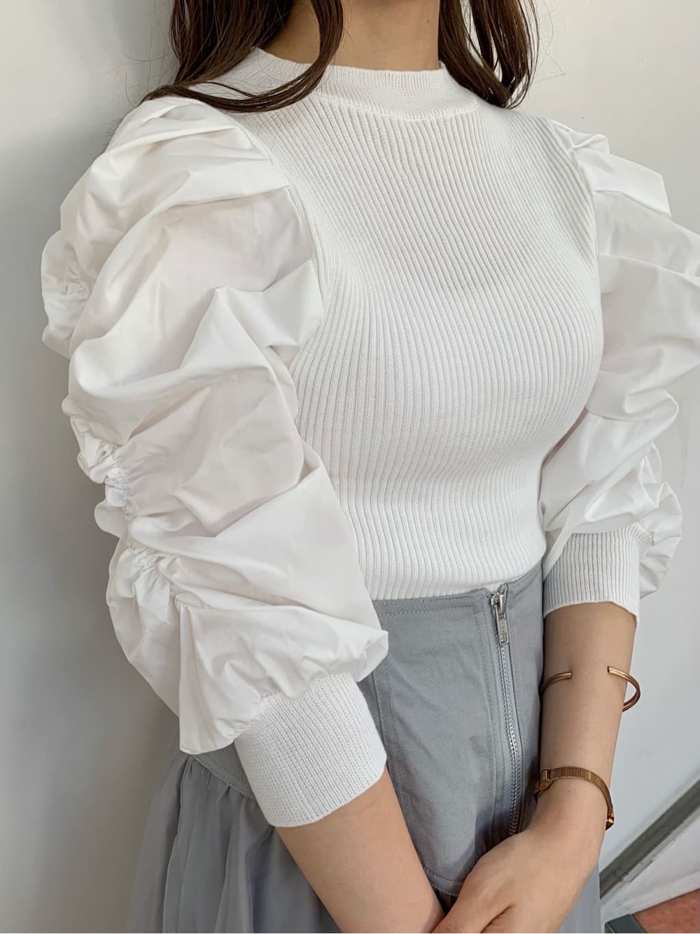 グレー系のスカート、ホワイト系のパンプス、ホワイト系のニット/セーターを着用したレディースの秋コーディネートの6枚目の写真