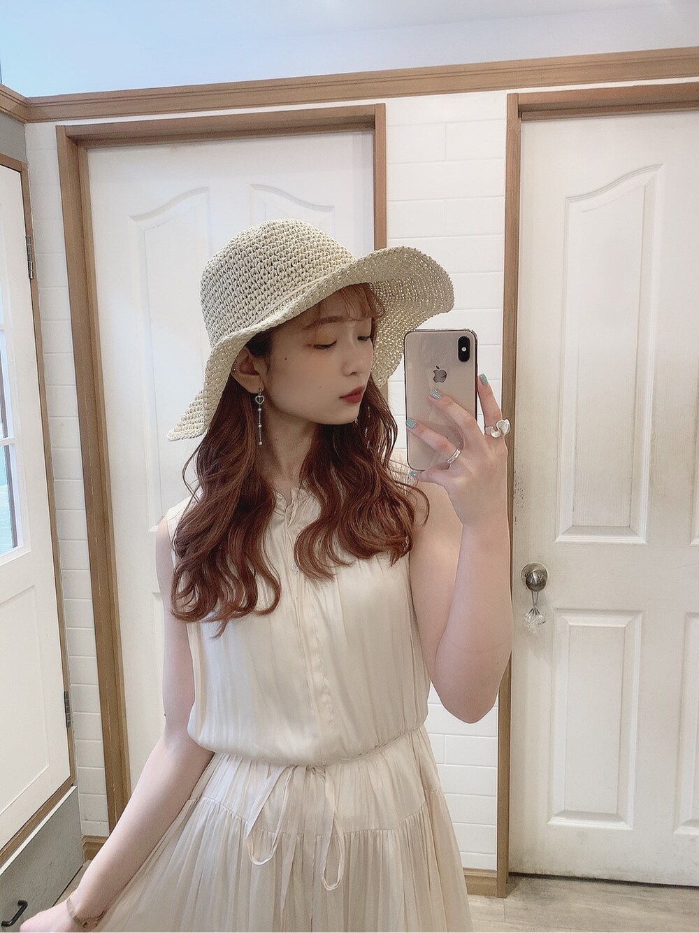 ホワイト系のブルゾン、ホワイト系のワンピース、ベージュ系のサンダルを着用したレディースの春コーディネートの3枚目の写真