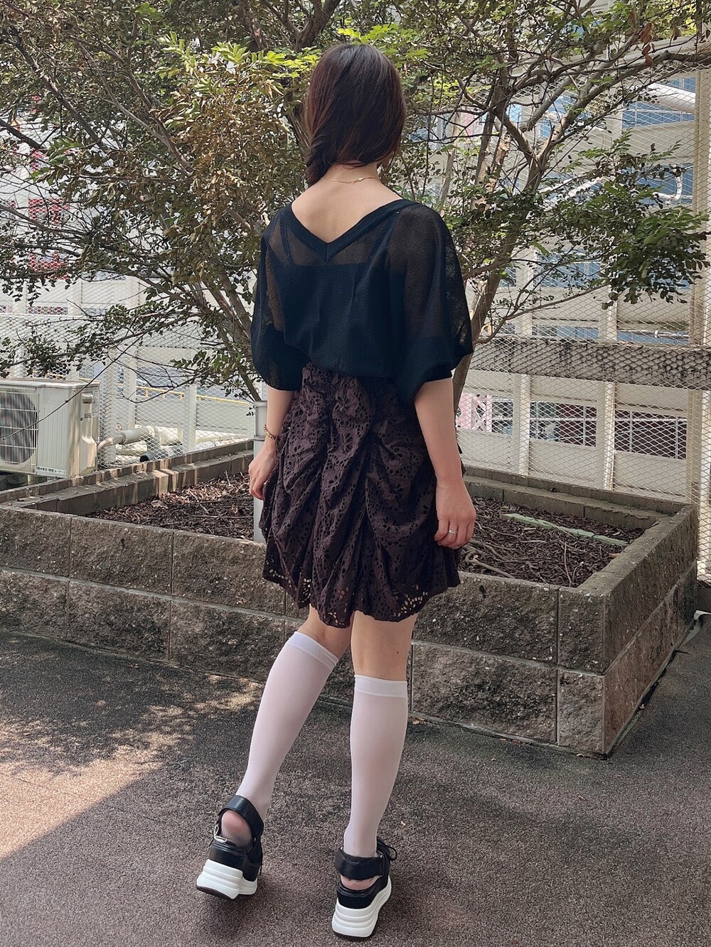 ブラック系のカーディガン/ボレロ、ブラウン系のワンピース、ブラック系のサンダルを着用したレディースの夏コーディネートの4枚目の写真