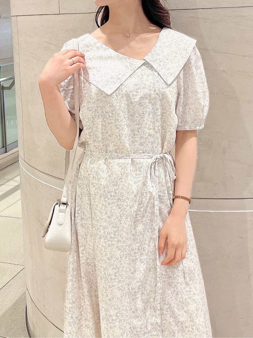 ベージュ系のサンダル、ホワイト系のワンピース、ホワイト系のハットを着用したレディースの春コーディネートの5枚目の写真