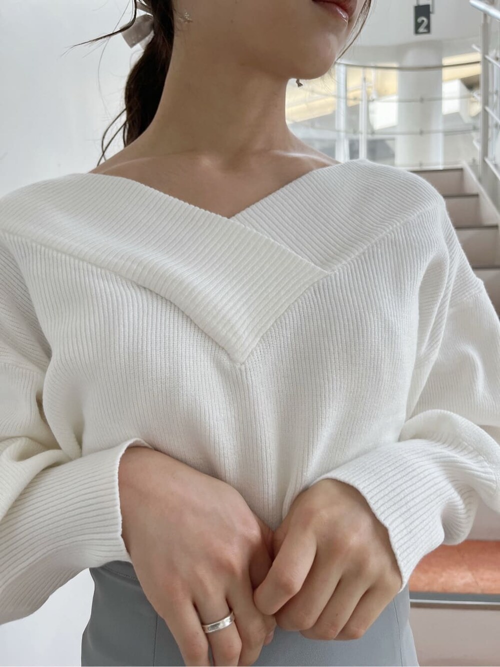 ベージュ系のブーツ、グレー系のスカート、ホワイト系のニット/セーターを着用したレディースの秋コーディネートの8枚目の写真