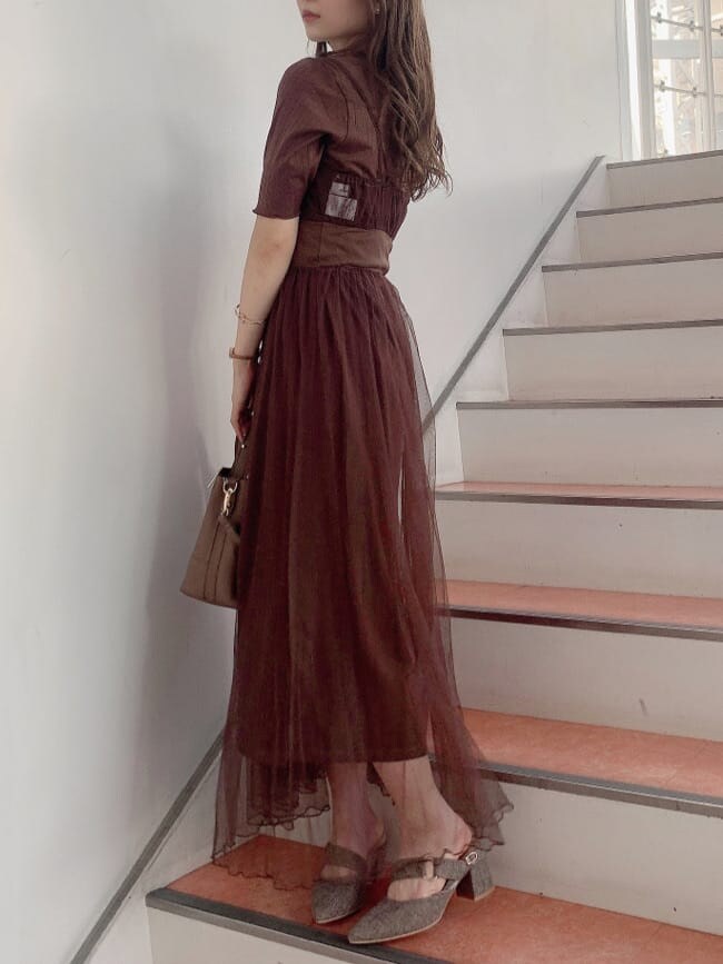 ブラウン系のワンピース、ブラウン系のパンプス、ベージュ系のハンドバッグを着用したレディースの秋コーディネートの3枚目の写真