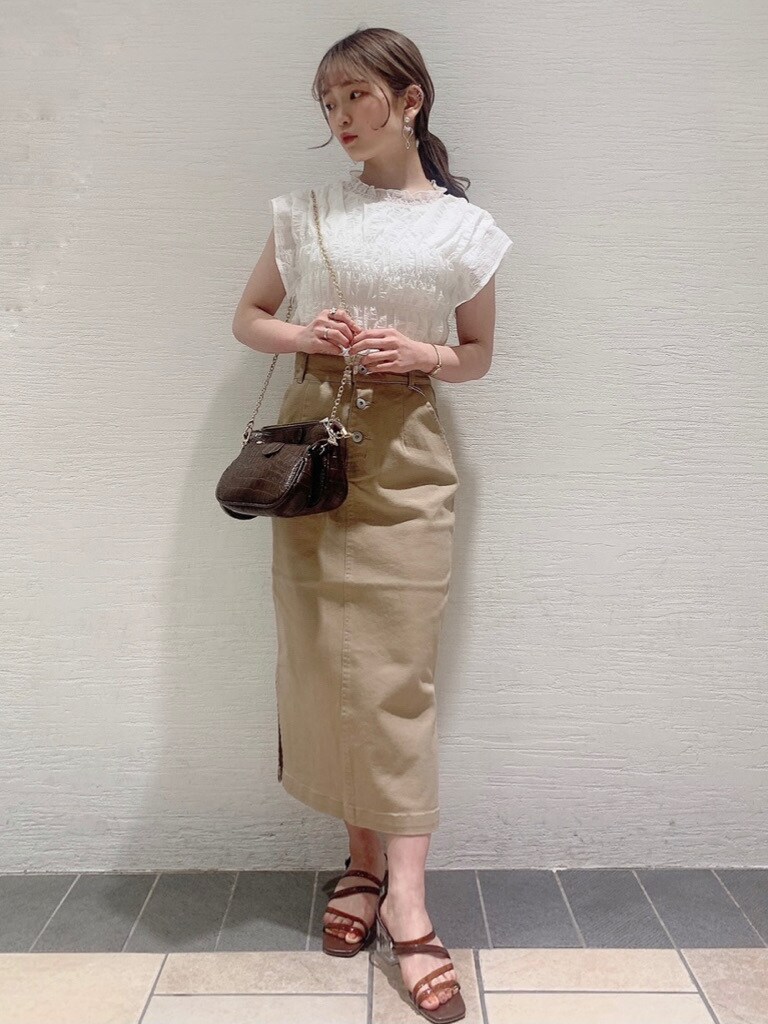ホワイト系のシャツ/ブラウス、ベージュ系のスカート、ブラウン系のサンダルを着用したレディースの春コーディネートの7枚目の写真