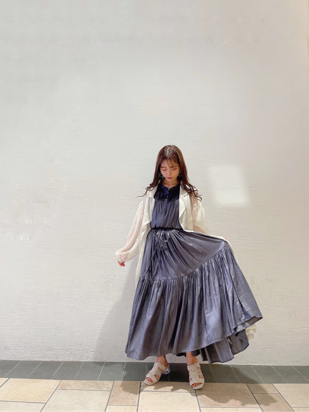 パープル系のワンピース、ホワイト系のサンダル、ホワイト系のシャツ/ブラウスを着用したレディースの春コーディネートの2枚目の写真