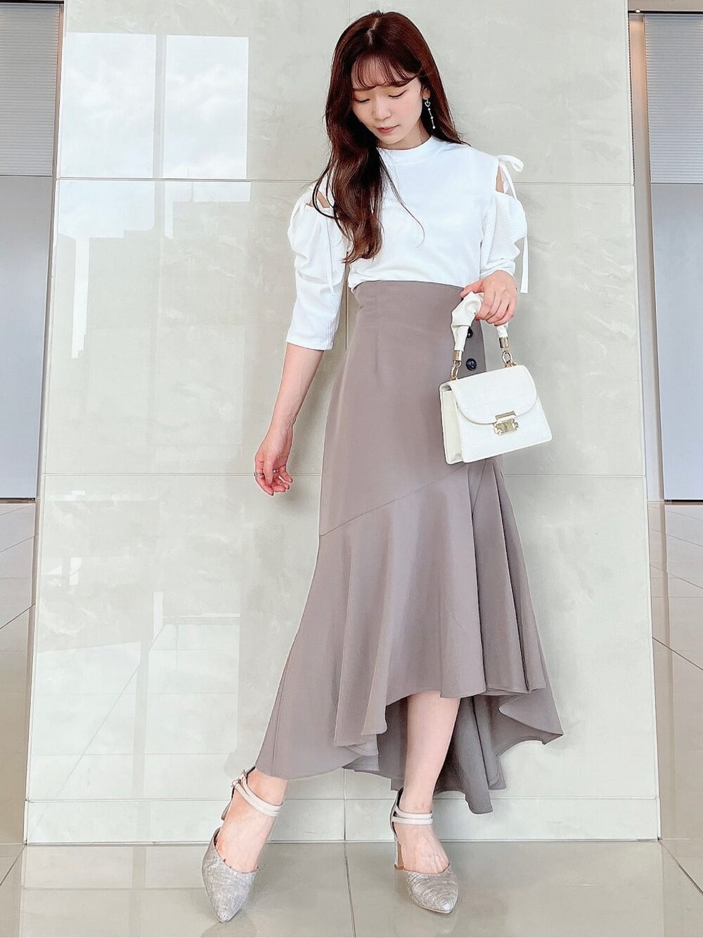 ベージュ系のスカート、ホワイト系のTシャツ/カットソーを着用したレディースの夏コーディネートの3枚目の写真