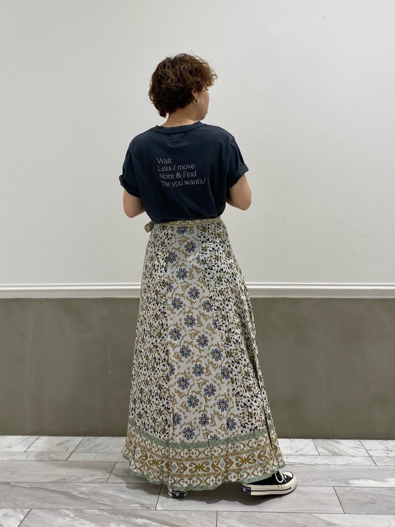 ホワイト系のスカート、グレー系のTシャツ/カットソーを着用したレディースの春コーディネートの2枚目の写真