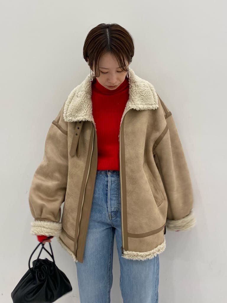 ブルー系のデニムパンツ、ベージュ系のムートンコート、ブルー系のデニムパンツを着用したレディースの秋コーディネートの8枚目の写真