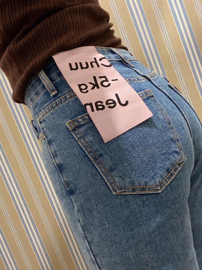 ブラウン系のニット/セーター、ブルー系のデニムパンツを着用したレディースの秋コーディネートの2枚目の写真