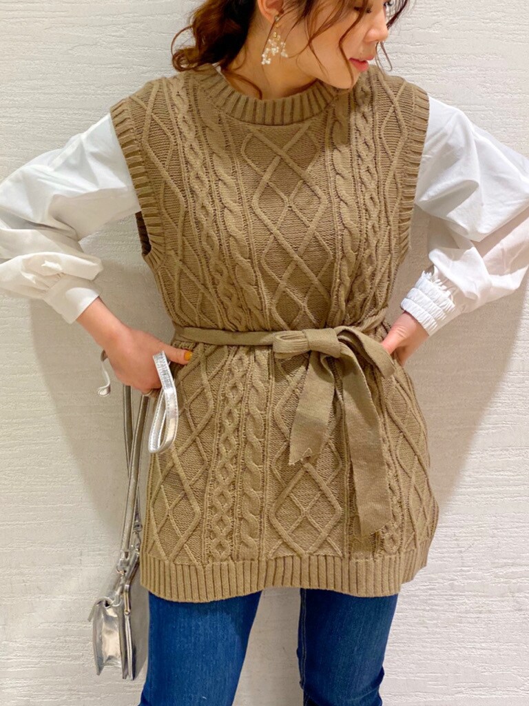 ブルー系のデニムパンツ、ホワイト系のパンプス、シルバー系のショルダーバッグを着用したレディースの春コーディネートの2枚目の写真