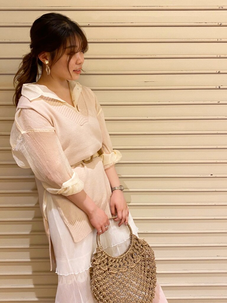 ベージュ系のハンドバッグ、ホワイト系のスカート、ホワイト系のシャツ/ブラウスを着用したレディースの夏コーディネートの4枚目の写真