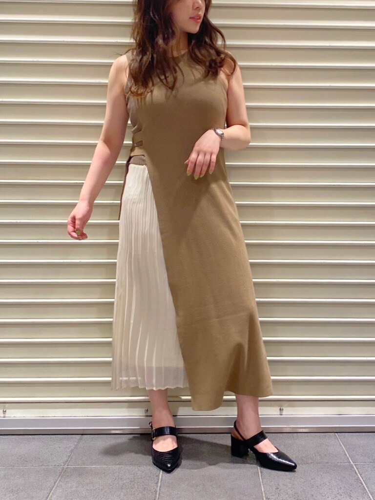 ベージュ系のトレンチコート、ブラック系のパンプス、ベージュ系のワンピースを着用したレディースの夏コーディネートの2枚目の写真