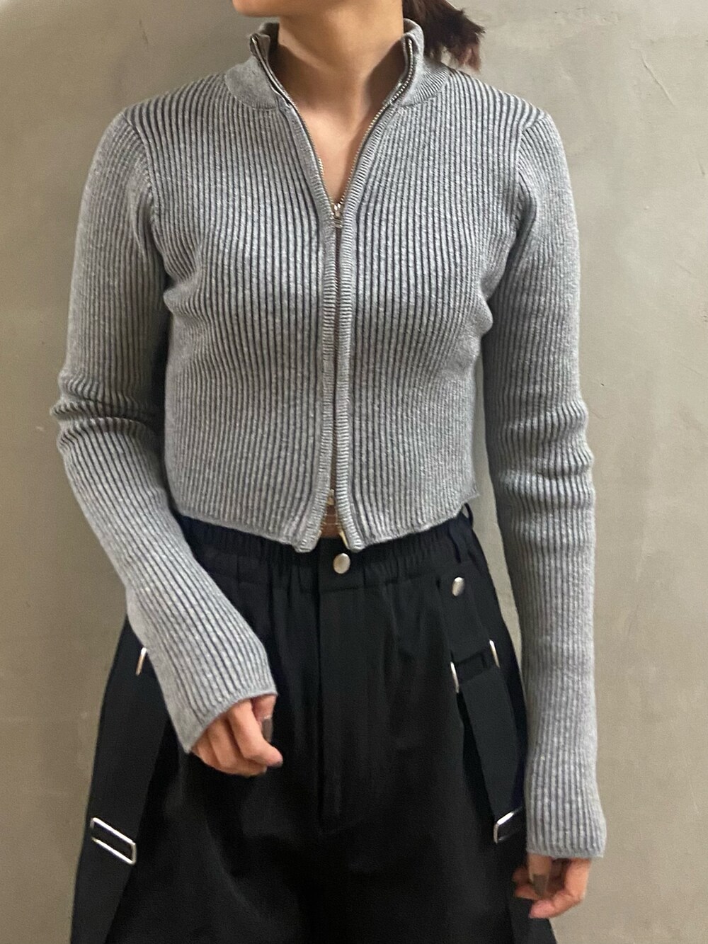 グレー系のニット/セーター、ブラック系のその他パンツ、ブラック系のブーツを着用したレディースの冬コーディネートの3枚目の写真