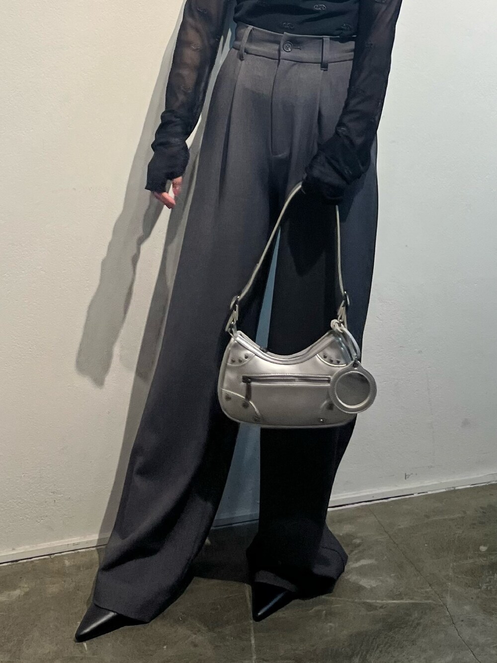 ブラック系のシャツ/ブラウス、グレー系のその他パンツ、シルバー系のハンドバッグを着用したレディースの冬コーディネートの5枚目の写真