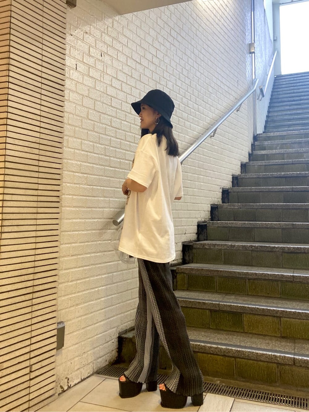 ブラック系のサンダル、その他のその他パンツ、ホワイト系のTシャツ/カットソーを着用したレディースの春コーディネートの3枚目の写真