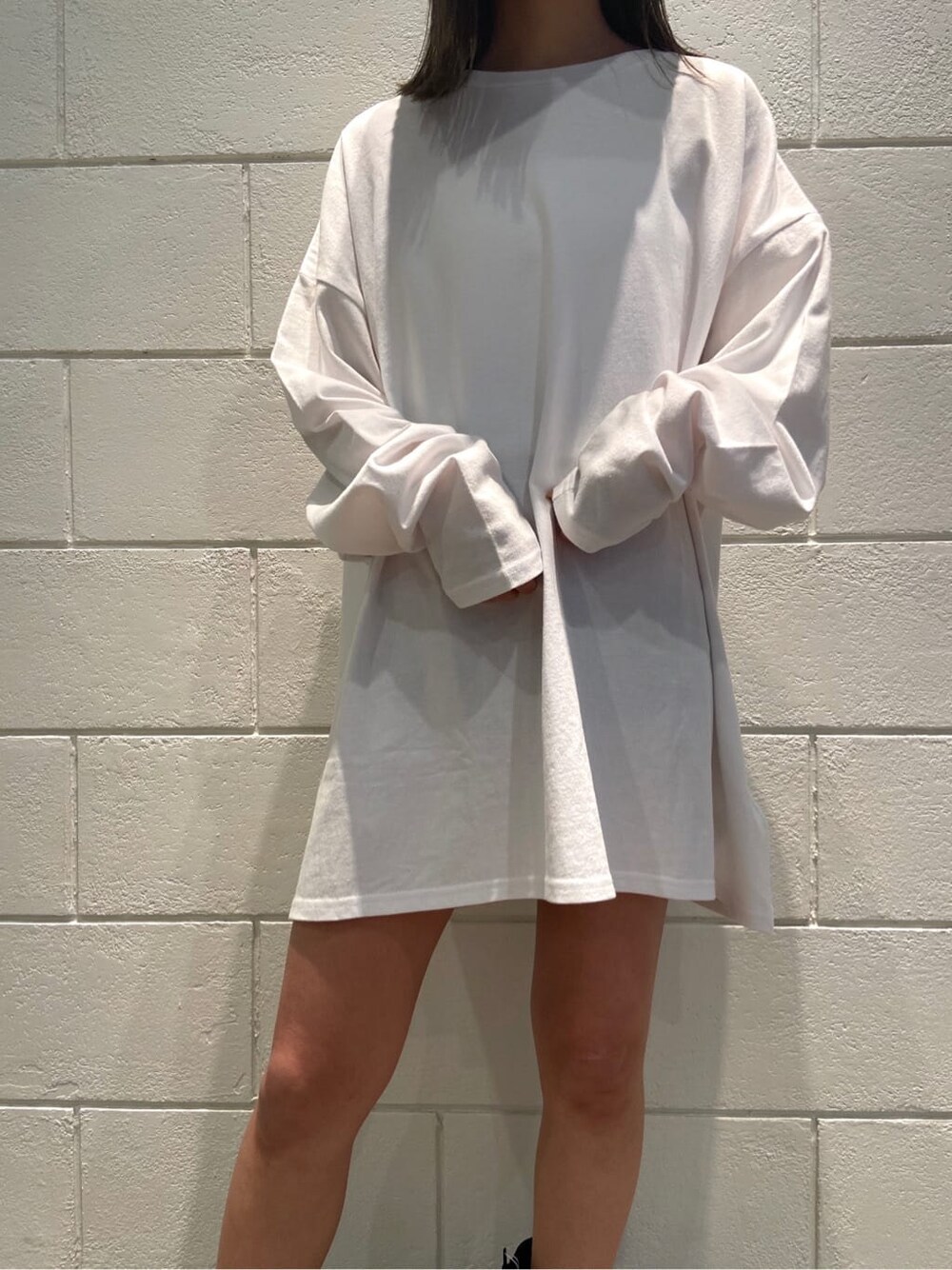 ブラック系のブーツ、ホワイト系のTシャツ/カットソー、ブラック系のハットを着用したレディースの冬コーディネートの3枚目の写真