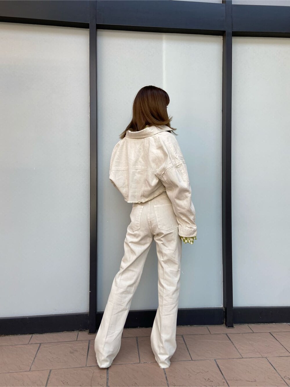 ホワイト系のデニムジャケット、グレー系のブーツ、その他のTシャツ/カットソーを着用したレディースの春コーディネートの6枚目の写真