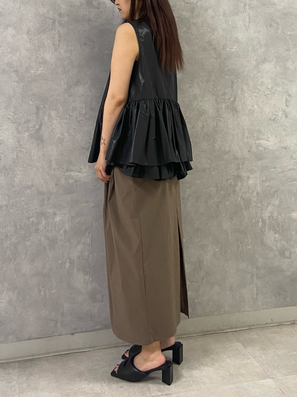 ブラック系のシャツ/ブラウス、ブラック系のサンダル、ブラウン系のスカートを着用したレディースの夏コーディネートの2枚目の写真