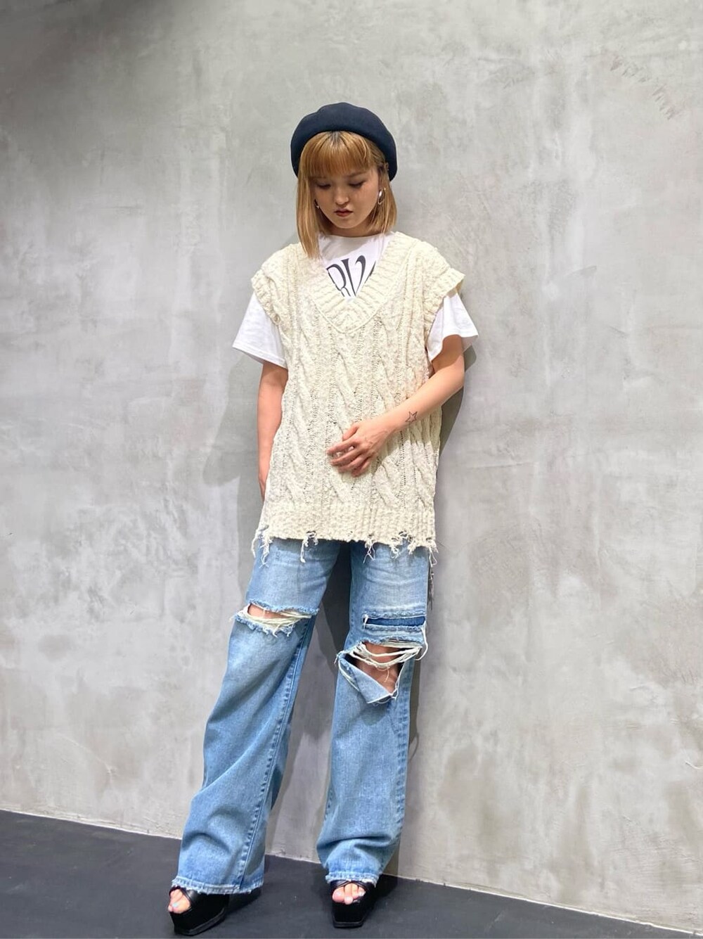 ブルー系のデニムパンツ、ホワイト系のベスト、ホワイト系のTシャツ/カットソーを着用したレディースの夏コーディネートの2枚目の写真