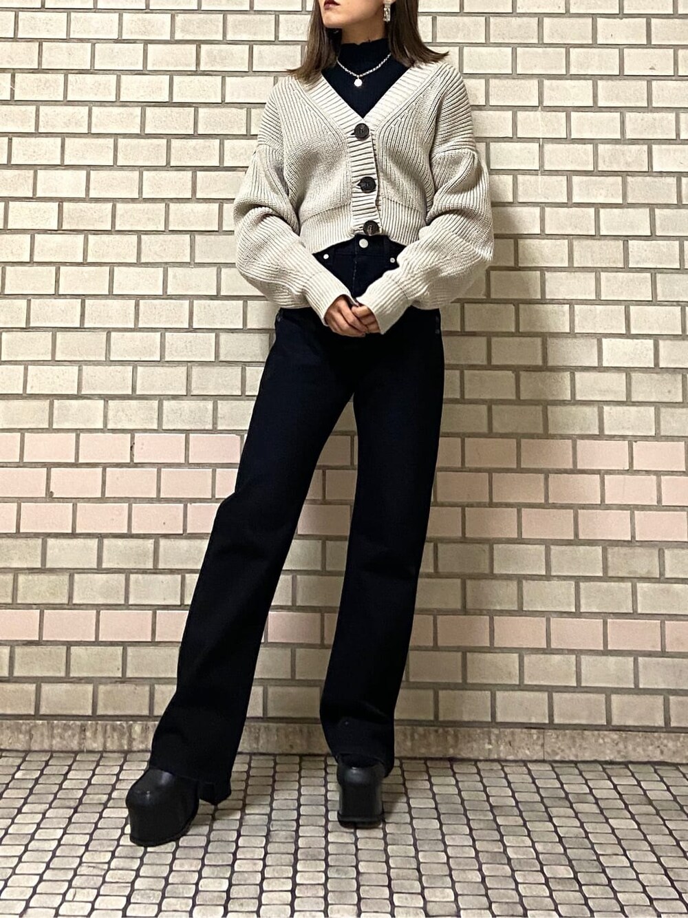 ブラック系のローファー、ブラック系のニット/セーター、ベージュ系のカーディガン/ボレロを着用したレディースの冬コーディネートの3枚目の写真