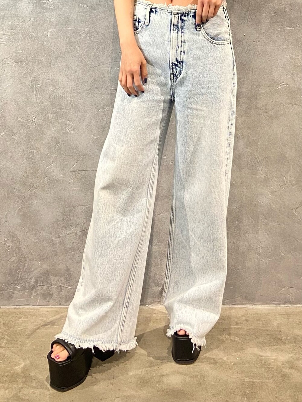 ブルー系のデニムパンツ、ブラック系のサンダルを着用したレディースの春コーディネートの6枚目の写真