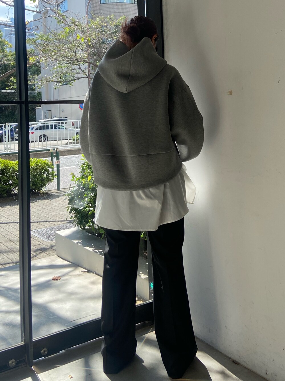 グレー系のパーカー、ブラック系のその他パンツ、シルバー系のサンダルを着用したレディースの秋コーディネートの3枚目の写真