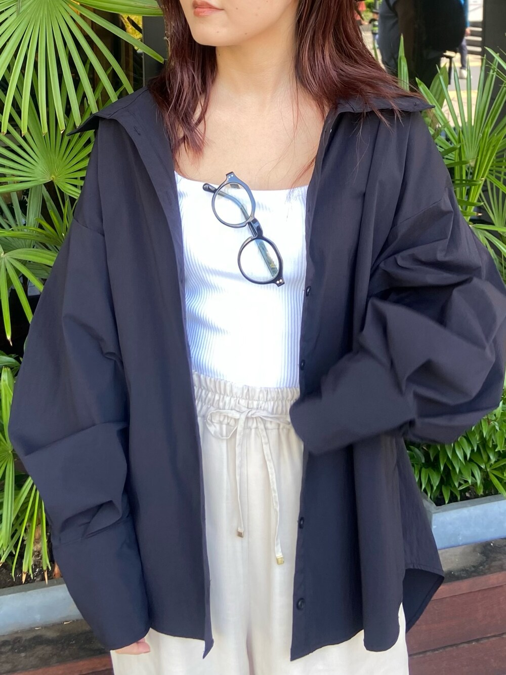 ホワイト系のタンクトップ、ホワイト系のその他パンツ、ブラック系のサンダルを着用したレディースの夏コーディネートの5枚目の写真