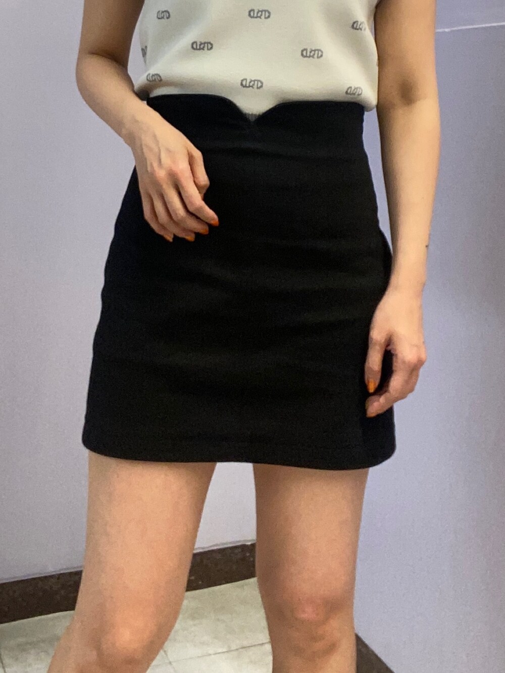 ホワイト系のニット/セーター、ブラック系のスカート、ブラック系のサンダルを着用したレディースの春コーディネートの5枚目の写真