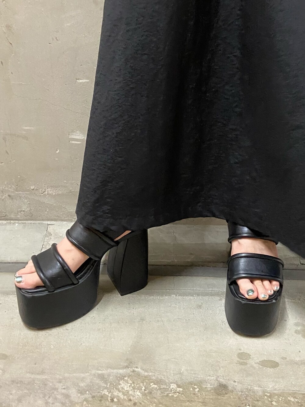 ブラック系のワンピース、ブラック系のサンダルを着用したレディースの夏コーディネートの3枚目の写真