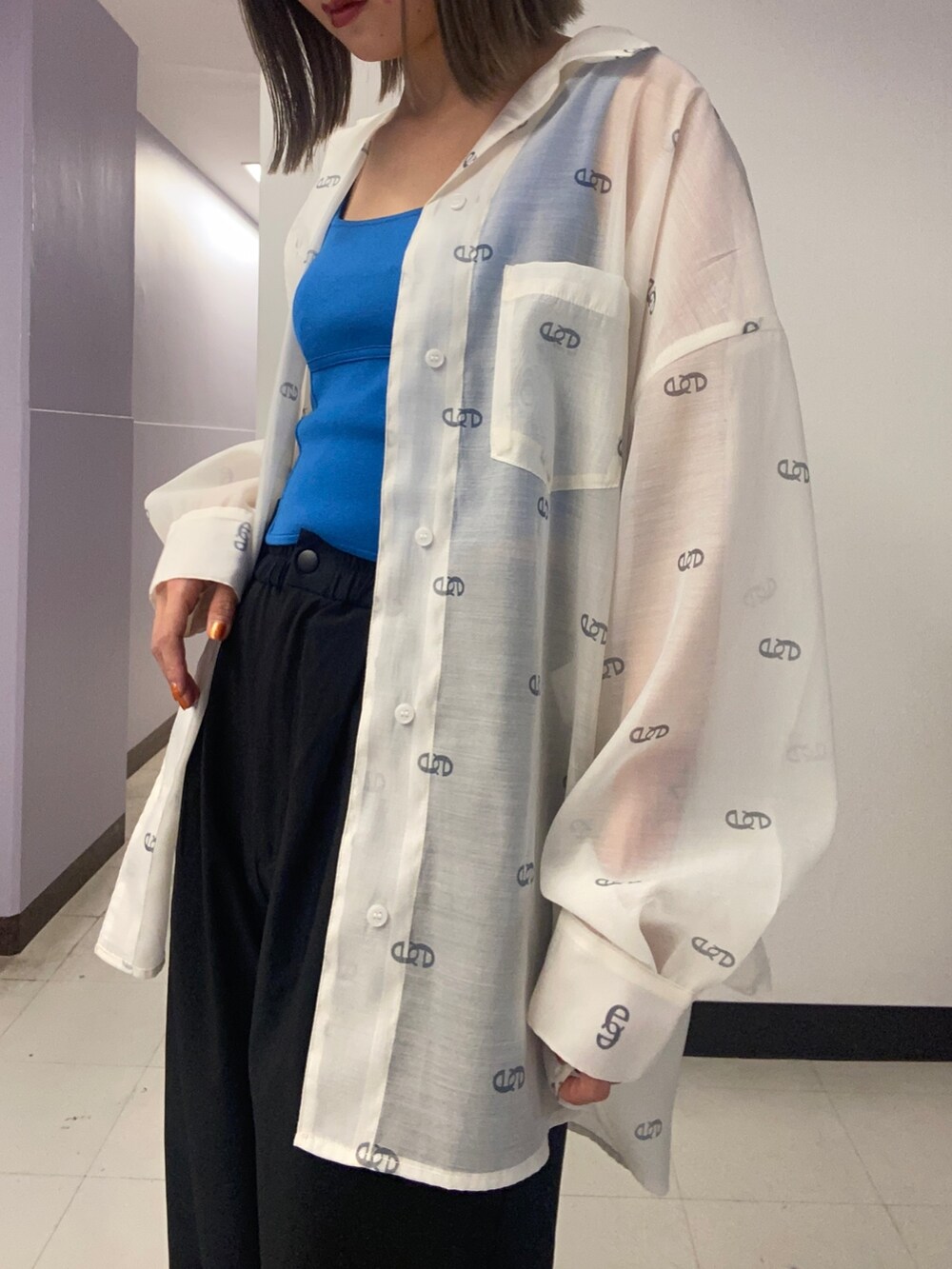 ホワイト系のシャツ/ブラウス、ブルー系のニット/セーター、ブラック系のその他パンツを着用したレディースの春コーディネートの3枚目の写真