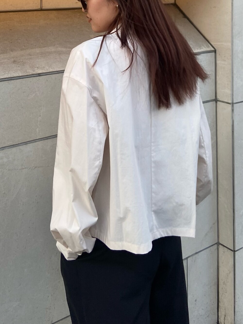 ホワイト系のテーラードジャケット、ブラック系のその他パンツ、ブラック系のサンダルを着用したレディースの春コーディネートの5枚目の写真