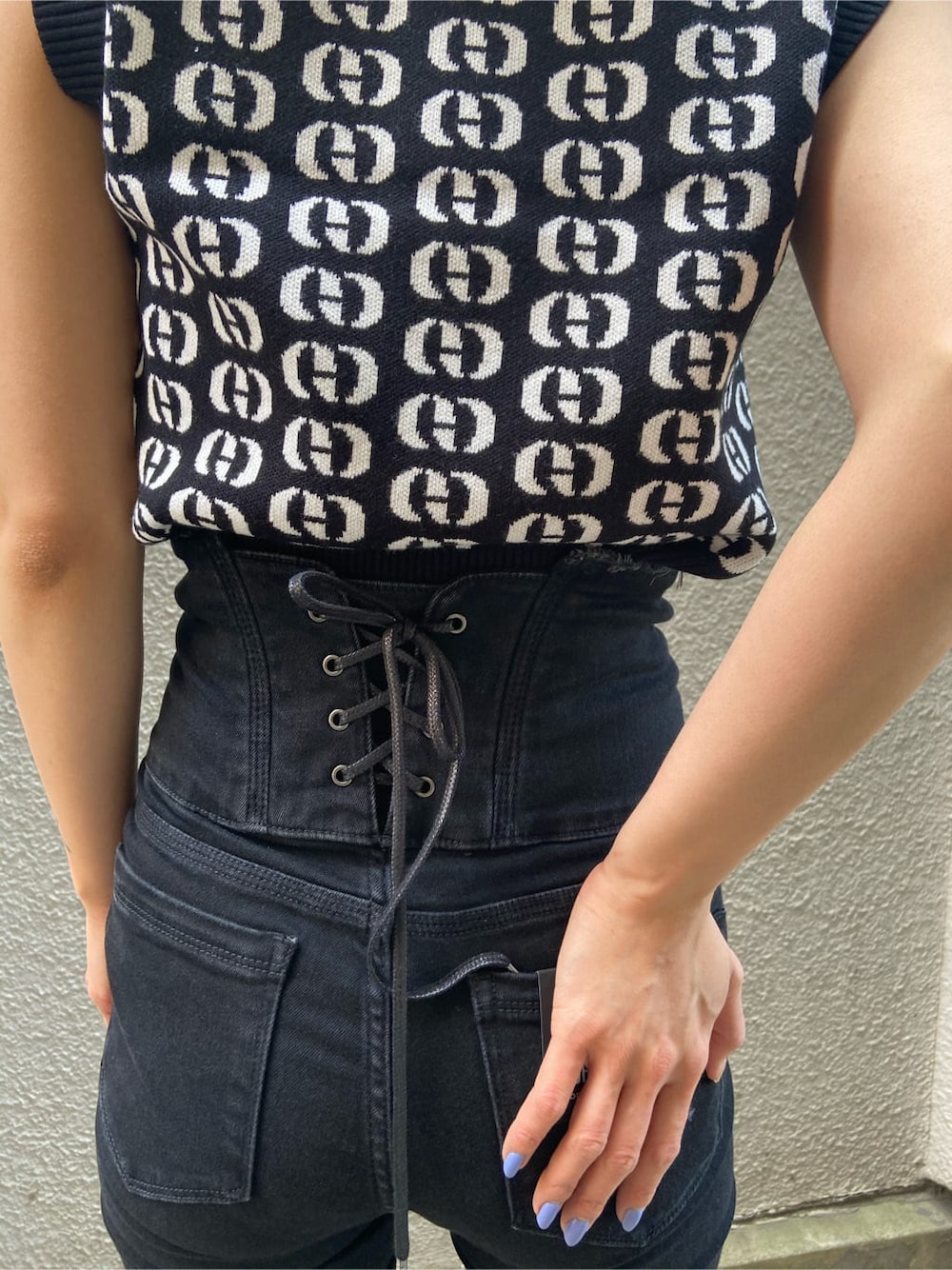 ブラック系のサンダル、その他のタンクトップ、ブラック系のデニムパンツを着用したレディースの春コーディネートの6枚目の写真