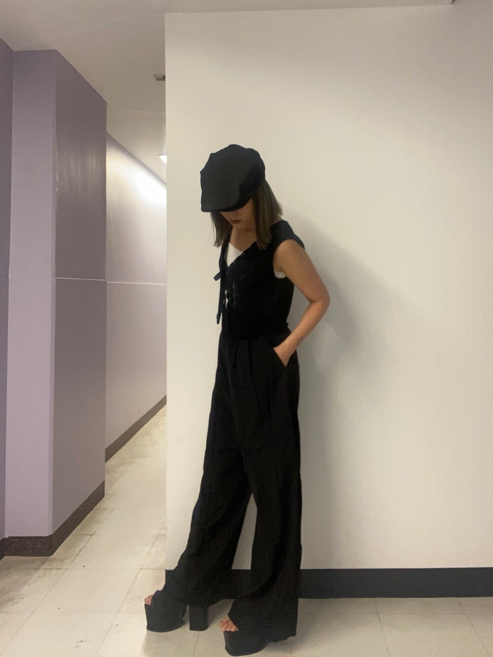 ブラック系のニット/セーター、ホワイト系のニット/セーター、ブラック系のその他パンツを着用したレディースの春コーディネートの2枚目の写真